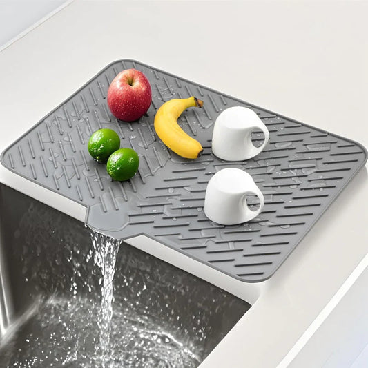 Hausify silicone dish drying mat with non-slip drain pad on kitchen counter for drying dishes and utensils.